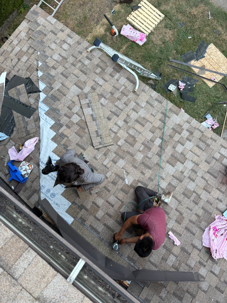 Aerial view roofing crew installing shingles hip roof Western PA — TriState Home Consulting Group