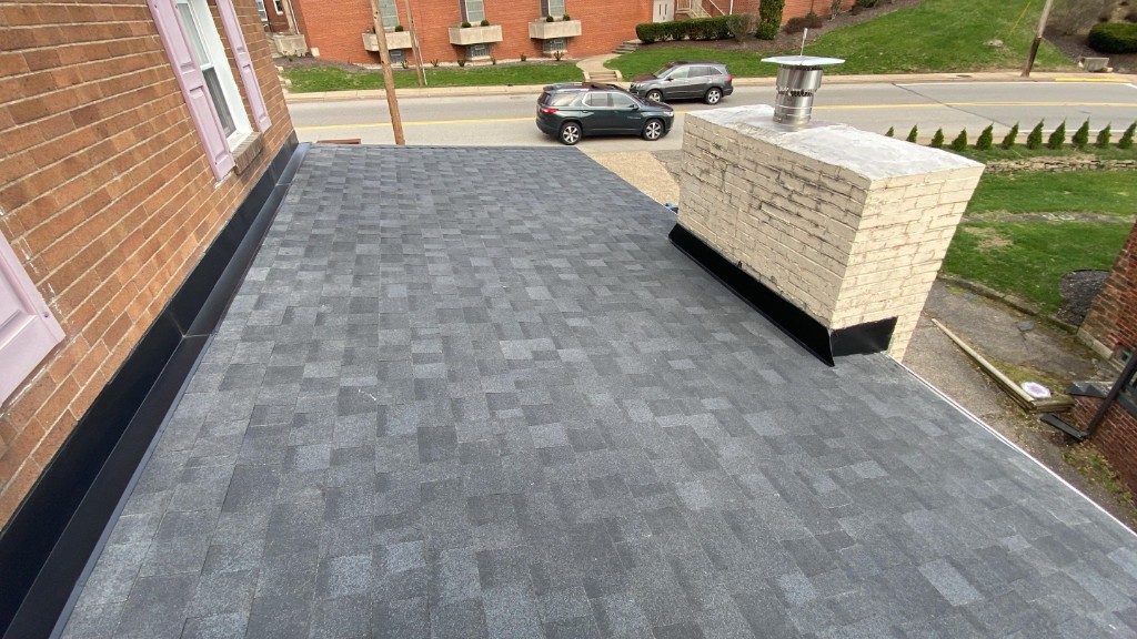 Completed flat roof replacement with chimney metal flashing Western PA — TriState Home Consulting Group